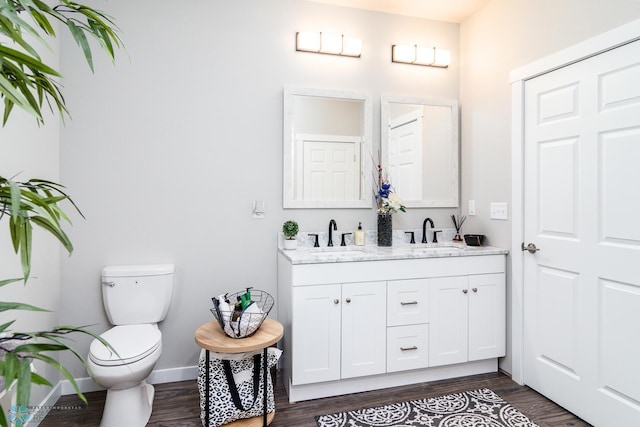 bathroom featuring hardwood / wood-style flooring, vanity, and toilet