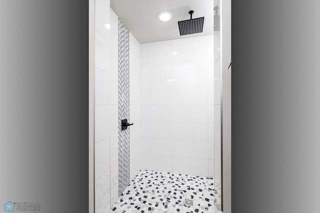 bathroom with a tile shower