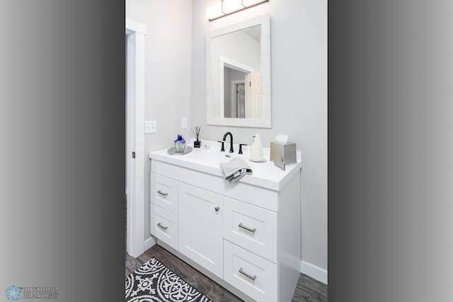 bathroom featuring hardwood / wood-style flooring and vanity