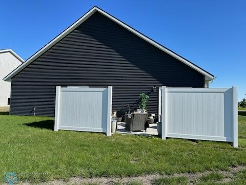 view of side of home with a lawn