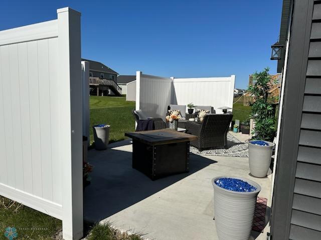 view of patio / terrace with an outdoor living space with a fire pit