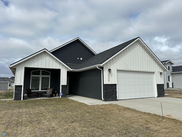 modern farmhouse style home with board and batten siding, stone siding, concrete driveway, and a garage