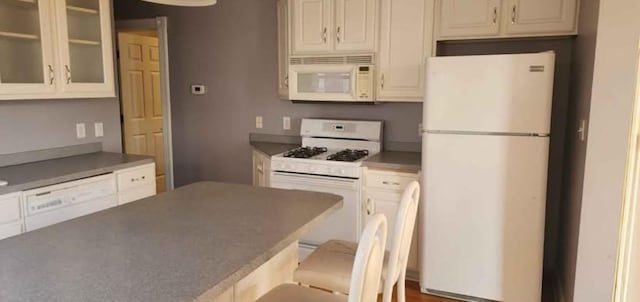 kitchen with white appliances and a breakfast bar