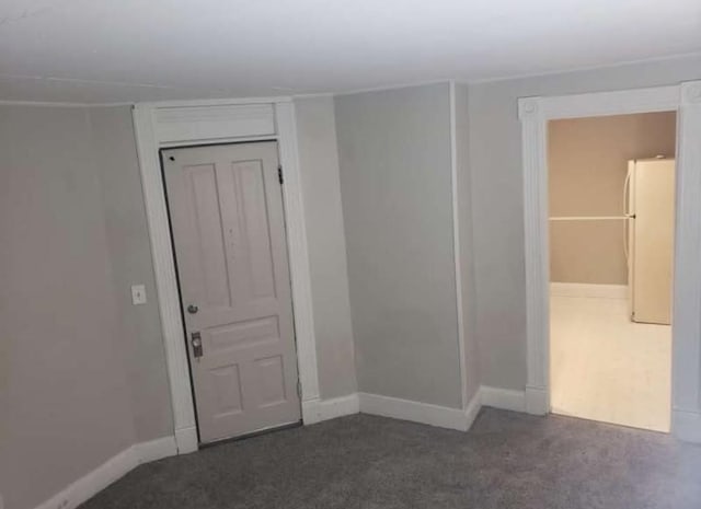 empty room with dark colored carpet