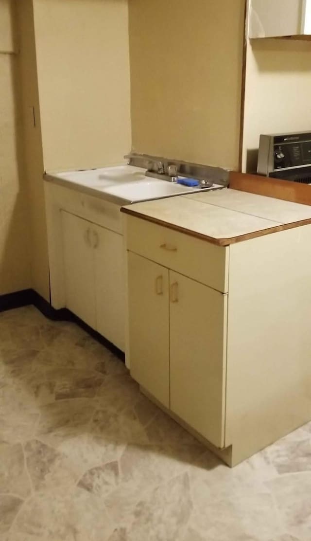 kitchen featuring sink and cream cabinetry