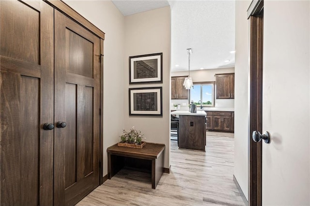 hallway with light hardwood / wood-style flooring