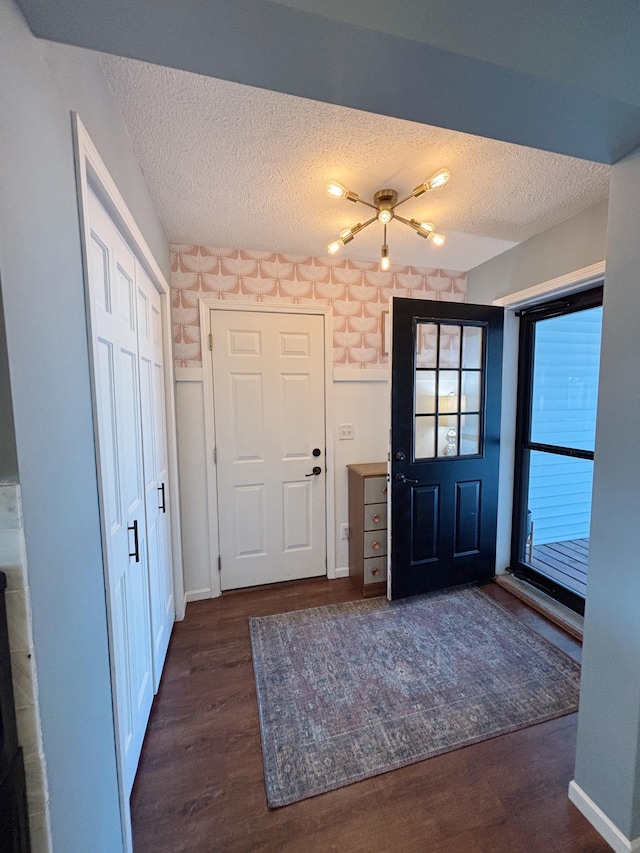 entrance foyer featuring a textured ceiling and dark hardwood / wood-style flooring