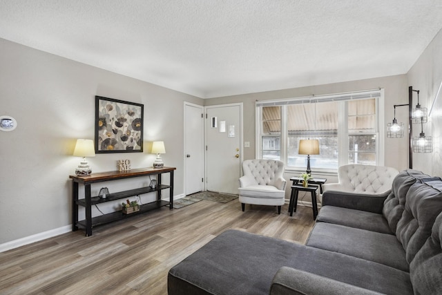 living room with hardwood / wood-style flooring and a textured ceiling