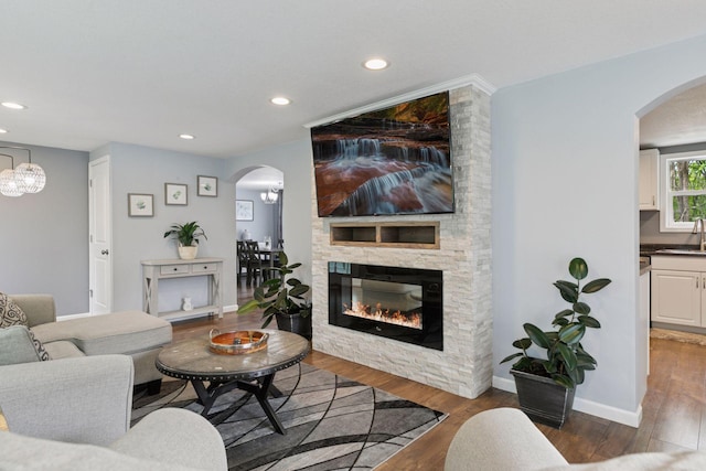 1524 Mulberry St, Taylors Falls, MN 55084 - living room with arched walkways, wood finished floors, recessed lighting, a fireplace, and baseboards