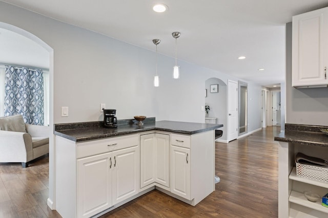 1524 Mulberry St, Taylors Falls, MN 55084 - kitchen with arched walkways, dark wood-type flooring, white cabinets, decorative light fixtures, and recessed lighting