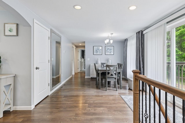 1524 Mulberry St, Taylors Falls, MN 55084 - dining space with a chandelier, wood finished floors, baseboards, recessed lighting, and arched walkways
