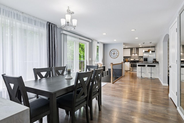 1524 Mulberry St, Taylors Falls, MN 55084 - dining room with a chandelier, dark wood-style floors, recessed lighting, and arched walkways