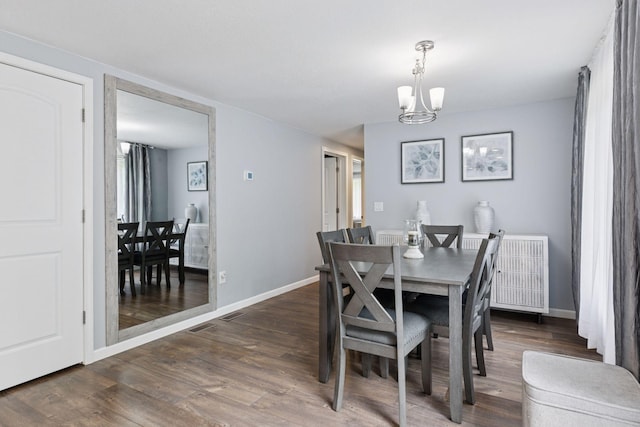 1524 Mulberry St, Taylors Falls, MN 55084 - dining room with a chandelier, wood finished floors, baseboards, and radiator