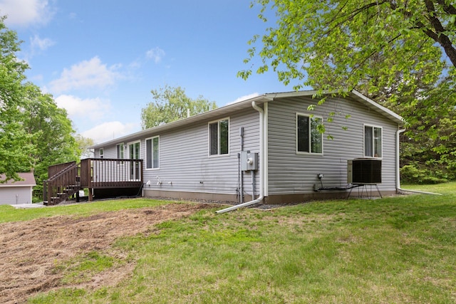1524 Mulberry St, Taylors Falls, MN 55084 - rear view of property featuring a wooden deck, a yard, and central AC unit