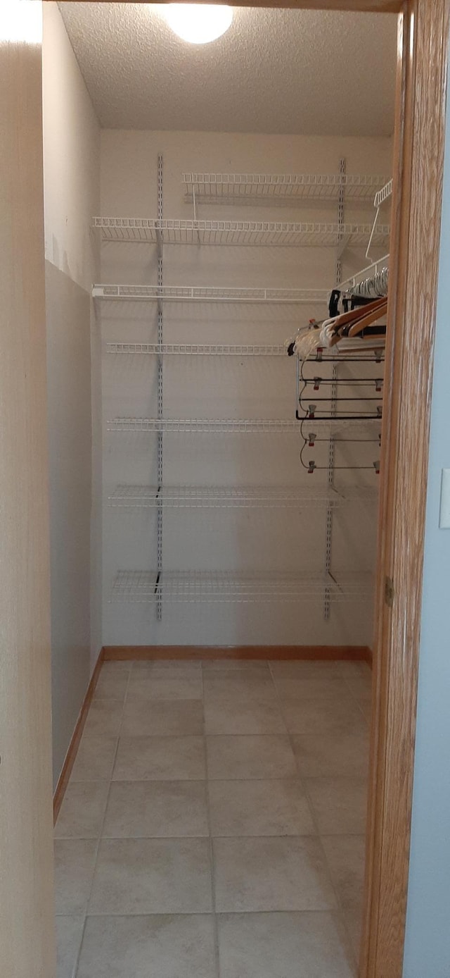 walk in closet featuring tile patterned flooring