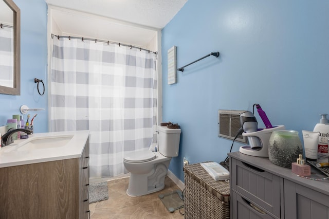 bathroom with vanity, a textured ceiling, and toilet