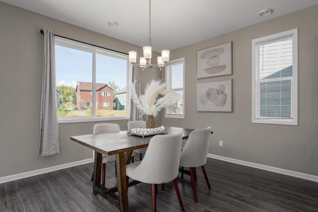 dining space with plenty of natural light, dark hardwood / wood-style floors, and a notable chandelier