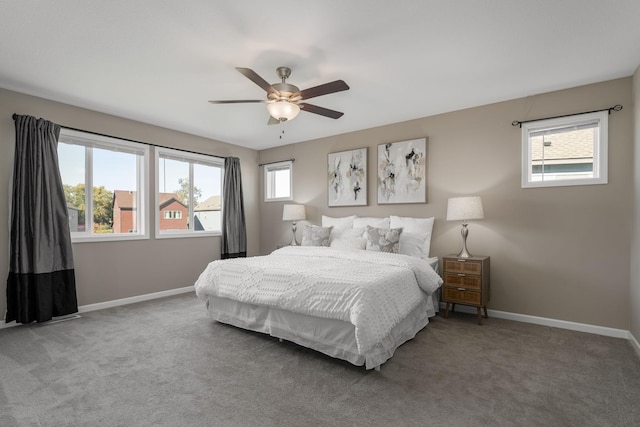 carpeted bedroom with multiple windows and ceiling fan