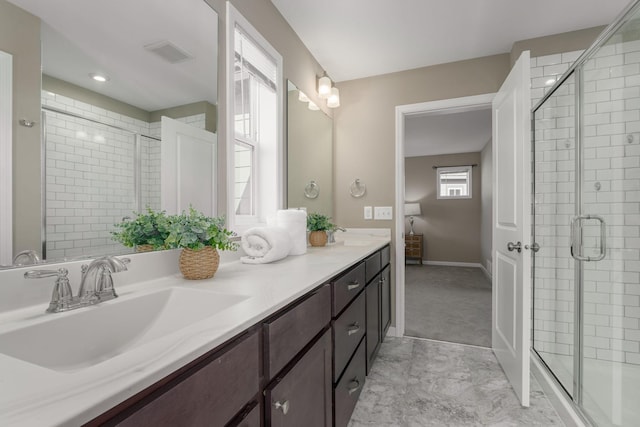 bathroom with vanity and a shower with door