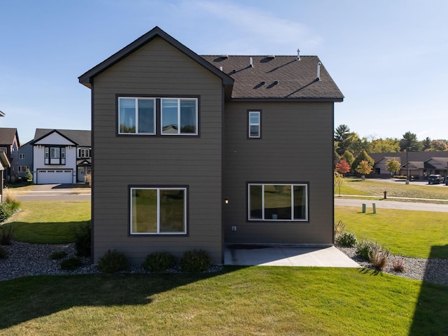 back of house featuring a patio and a lawn