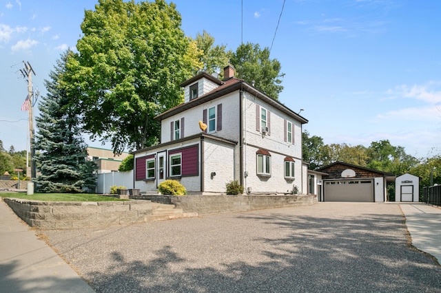 view of front facade with an outbuilding and a garage