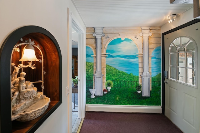 doorway to outside with dark colored carpet and a baseboard radiator