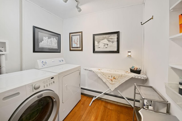 laundry area featuring a baseboard heating unit, wood-type flooring, washer and dryer, and track lighting