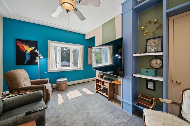 sitting room with ceiling fan, carpet, ornamental molding, and baseboard heating