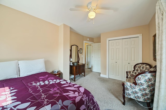 carpeted bedroom with ceiling fan and a closet