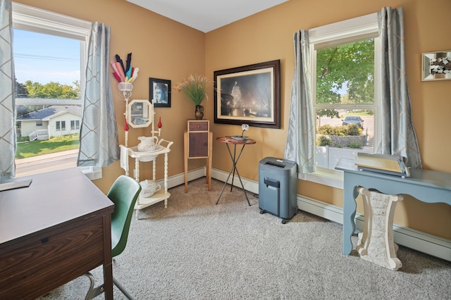 office space with a baseboard heating unit and carpet floors