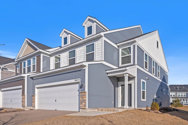 view of front of house with stone siding and a garage