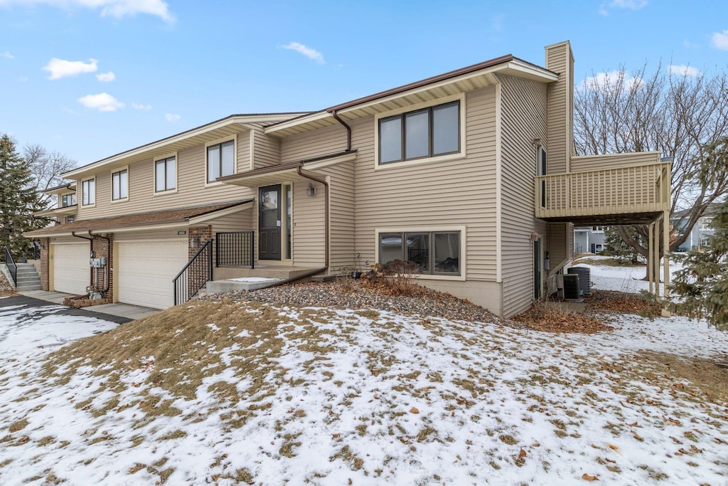 split foyer home featuring central AC and a garage