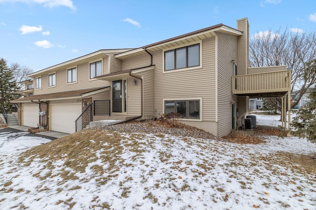 split foyer home featuring central AC and a garage