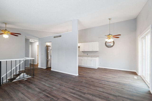 empty room featuring lofted ceiling, dark hardwood / wood-style floors, and ceiling fan