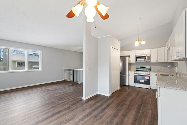 kitchen featuring sink, white cabinetry, hanging light fixtures, stainless steel appliances, and light stone countertops