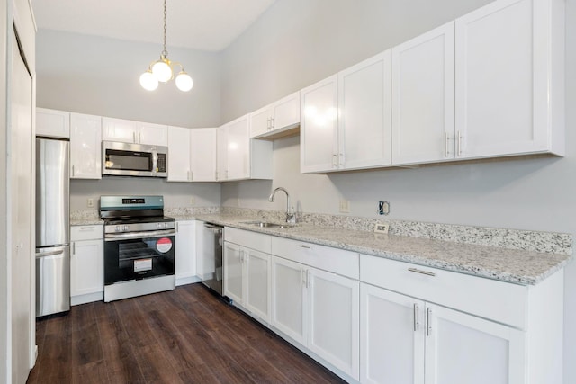 kitchen with appliances with stainless steel finishes, sink, and white cabinets