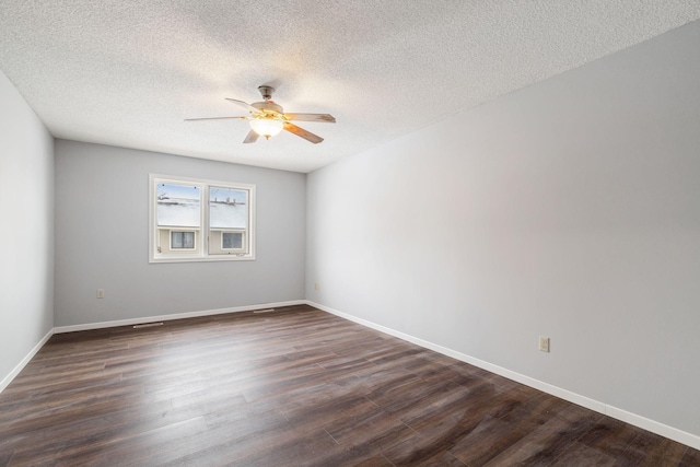 empty room with dark hardwood / wood-style flooring, ceiling fan, and a textured ceiling