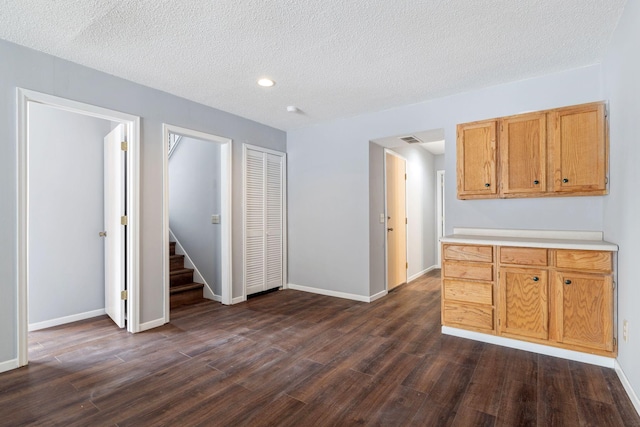 kitchen featuring dark hardwood / wood-style floors and a textured ceiling