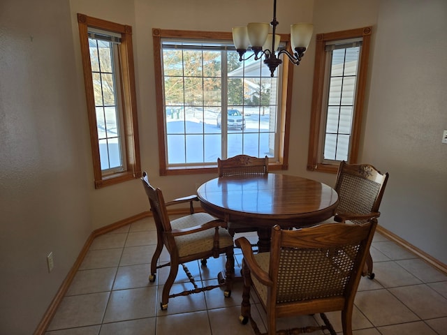 tiled dining space with a notable chandelier