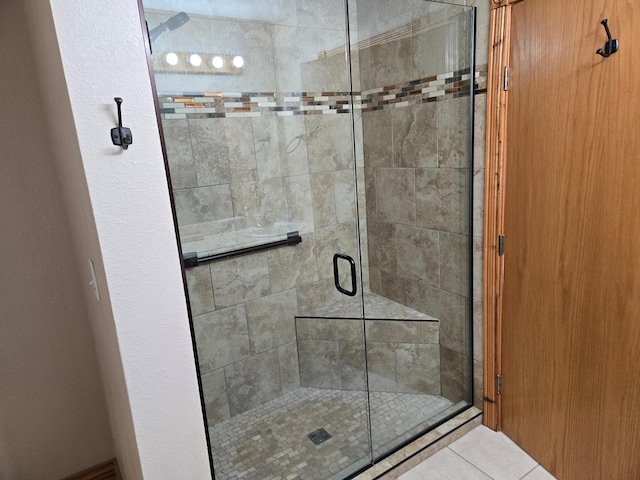 bathroom featuring tile patterned floors and an enclosed shower