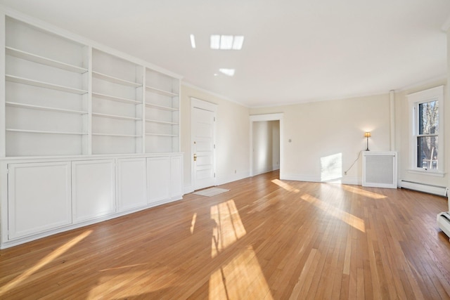 unfurnished living room featuring a baseboard heating unit, hardwood / wood-style floors, and built in shelves