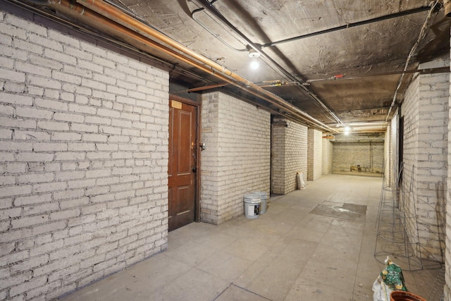 unfinished below grade area with brick wall