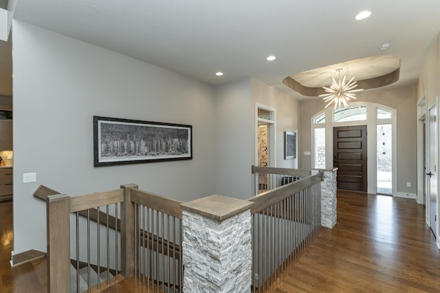 hall with an upstairs landing, recessed lighting, baseboards, and wood finished floors