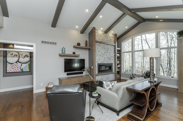 living area featuring visible vents, vaulted ceiling with beams, baseboards, a fireplace, and wood finished floors