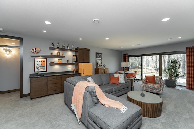 living area featuring recessed lighting, baseboards, light carpet, and a bar