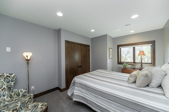 bedroom with a closet, recessed lighting, baseboards, and dark colored carpet