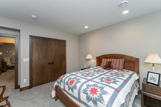 bedroom with recessed lighting, a closet, light carpet, and baseboards