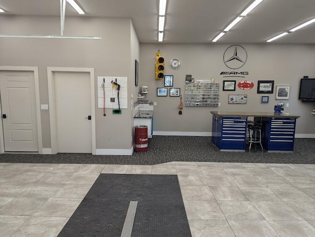 garage featuring a workshop area and baseboards