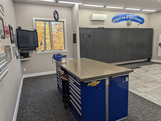 office space featuring baseboards and an AC wall unit