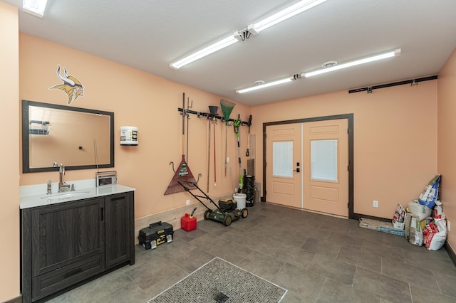 garage with french doors and a sink